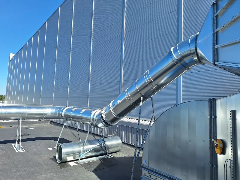 Duct rising to the hall wall