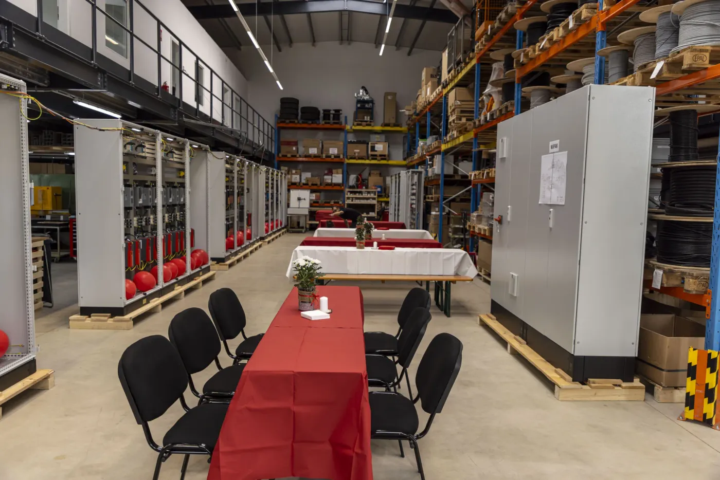 The set tables between shelving and control cabinets