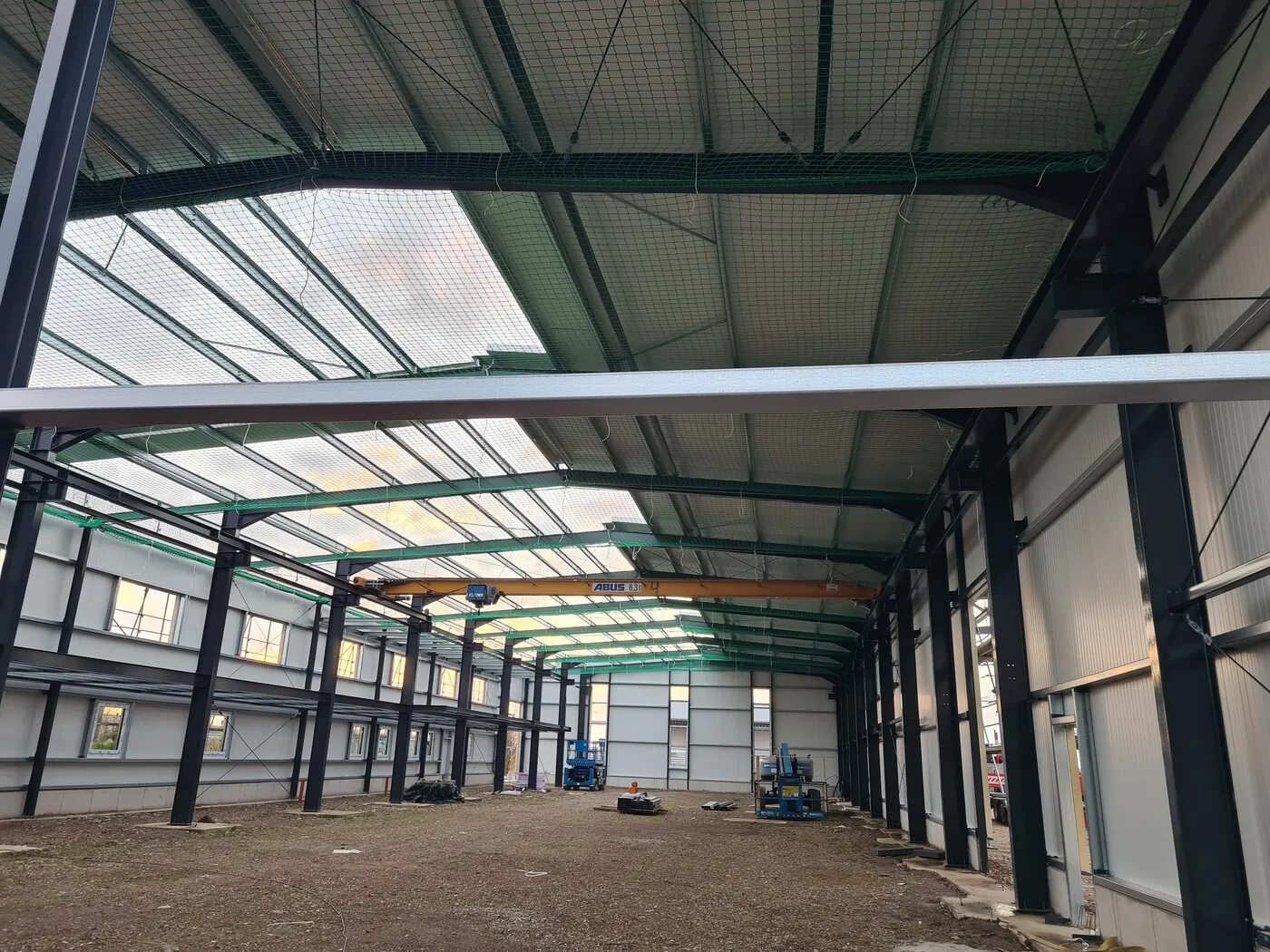 Inside the hall with finished wall and roof cladding, floor not yet laid