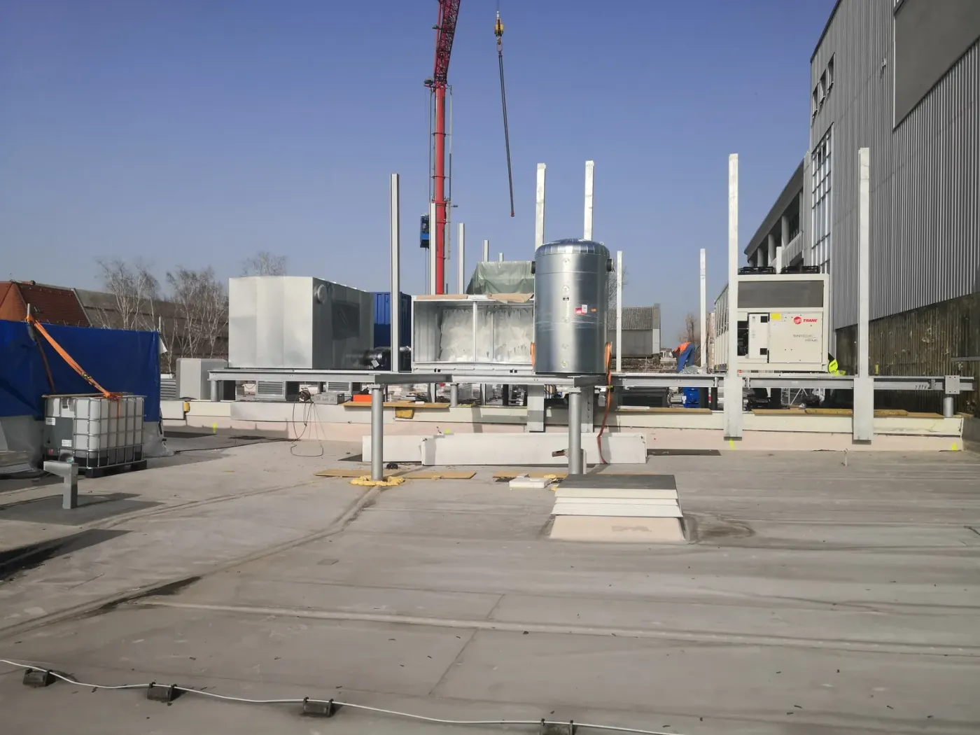 Roof during construction with crane and exhaust stacks