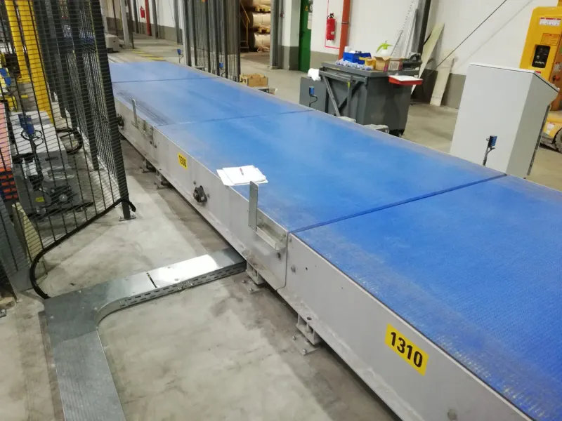 Long modular belt conveyor by the safety fence