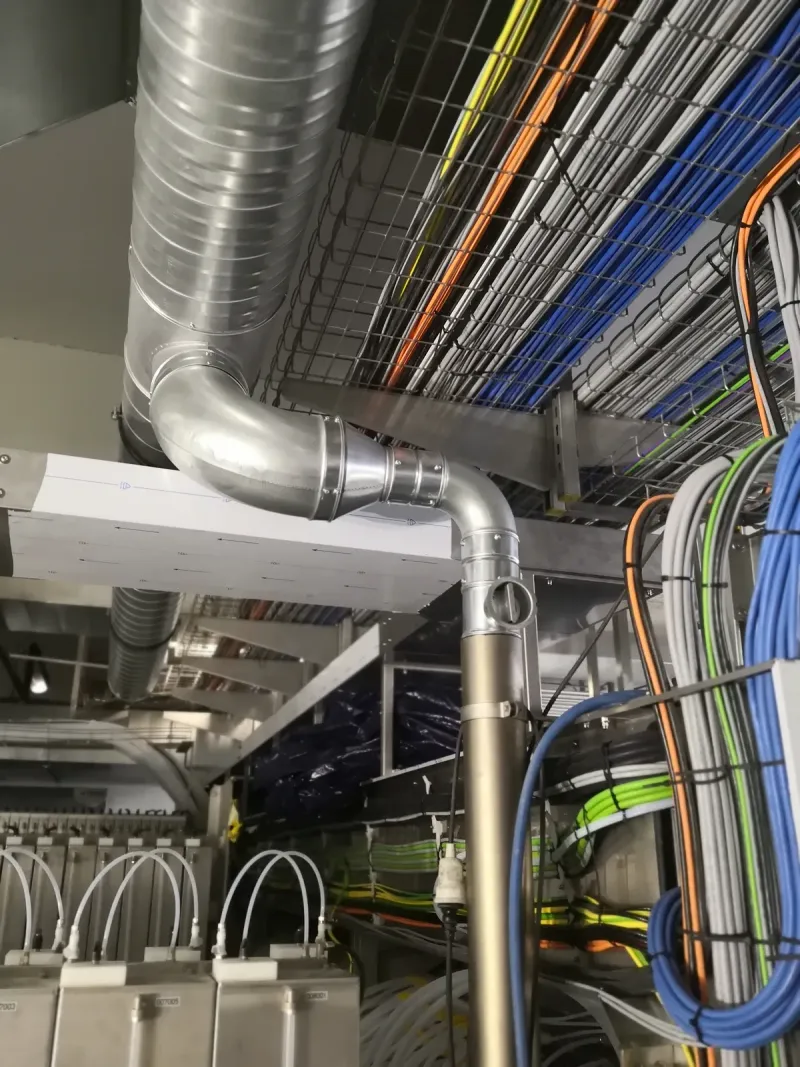 Cable trays and air duct at the ceiling