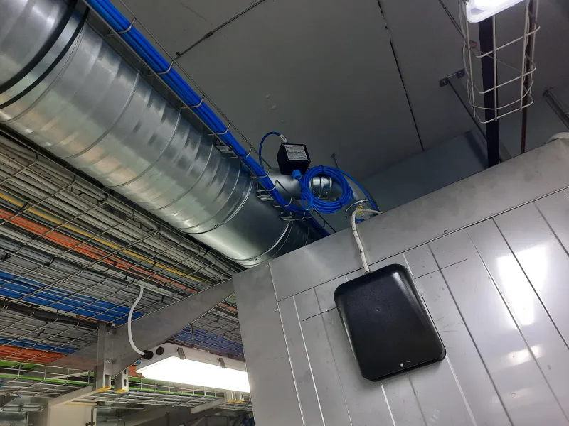 Cable trays above an air handling unit