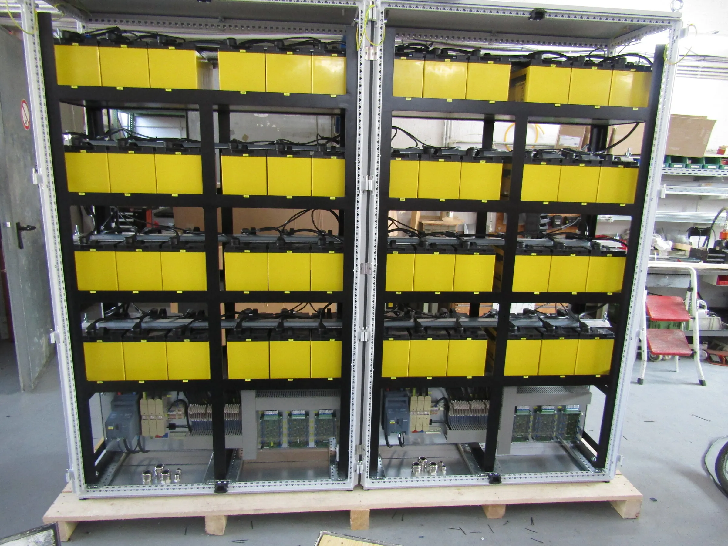 Battery backup for ten lifting magnets: two cabinets full of batteries with the control section below